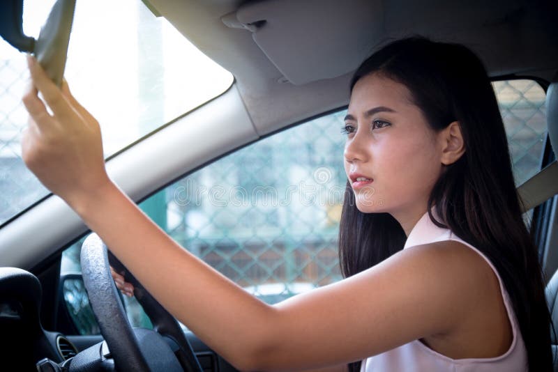 Young attractive woman driver sitting on seat inside car using h royalty free stock photography Young attractive woman driver sitting on seat inside car using h royalty free stock photography