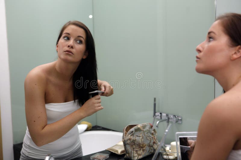 Young attractive woman getting ready in bathroom