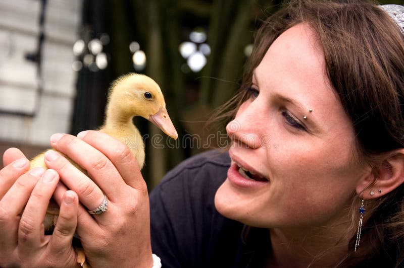 Young Attractive Woman Holding Duckling