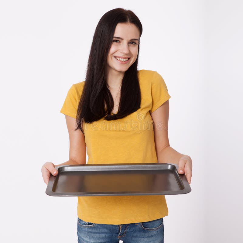 Young attractive woman holding an empty tray on white background. stock photo Young attractive woman holding an empty tray on white background. stock photo