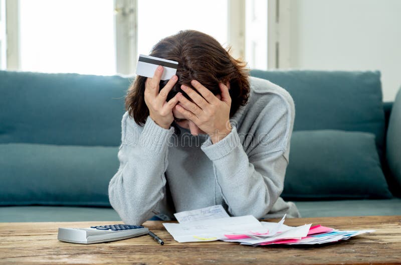 Upset young woman stressed about credit card debts and payments not happy accounting finances