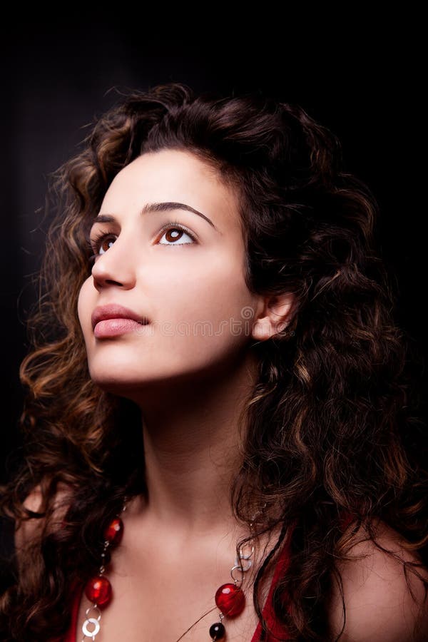 Young and attractive woman looking up smiling