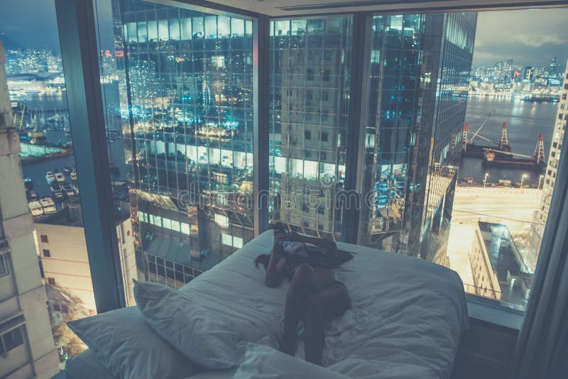 Young attractive woman making self portrait in the bed in the evening