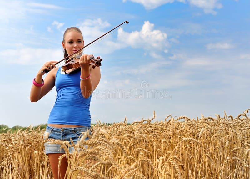 Young attractive woman playing the violin