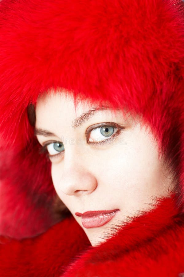 Young attractive woman in red fur-cap