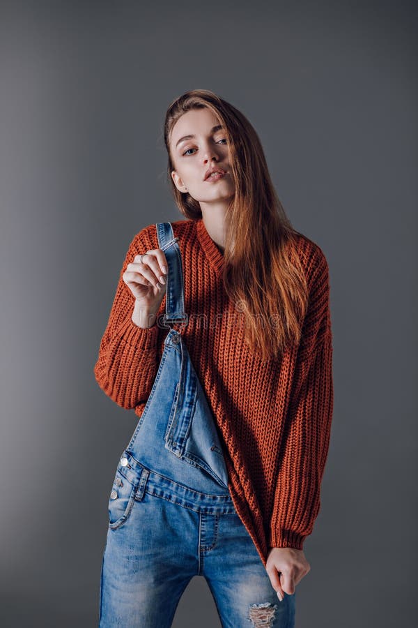 Young Attractive Woman in a Red Sweater on a Gray Background Stock ...