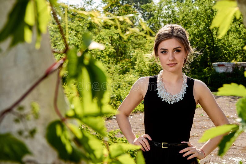 Young attractive woman in the sexy transparent black dress. Young woman portrait