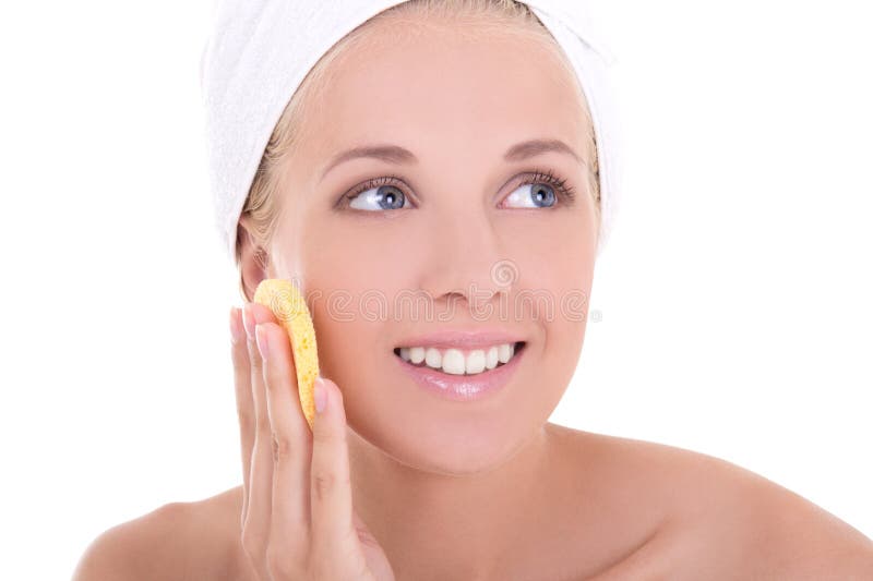 Young attractive woman with sponge washing her face