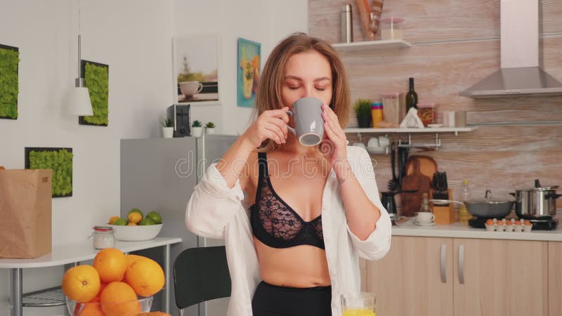sexy and beautiful girl in lingerie in the kitchen preparing breakfast  Stock Photo