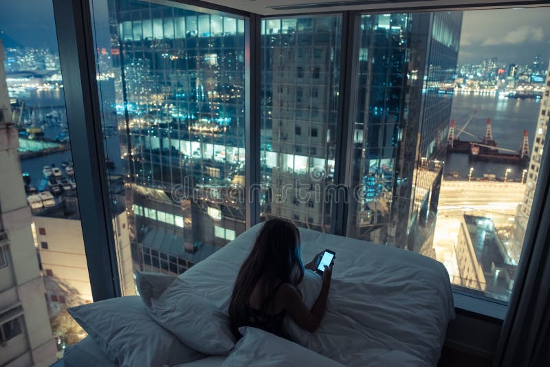 Young attractive woman using mobile phone in the bed