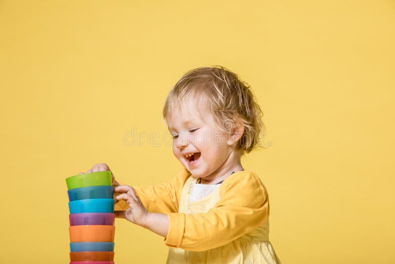 Young Baby Girl in Yellow Dress on Yellow Background royalty free stock photos Young Baby Girl in Yellow Dress on Yellow Background royalty free stock photos