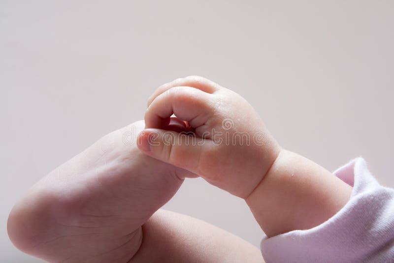 Young baby grabbing her feet