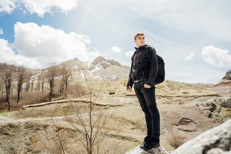 Young backpacker hiker man enjoying adrenaline mountain hike.Active hiking trip vacation.Climbing to the top of mountain cliff. stock photography Young backpacker hiker man enjoying adrenaline mountain hike.Active hiking trip vacation.Climbing to the top of mountain cliff. stock photography