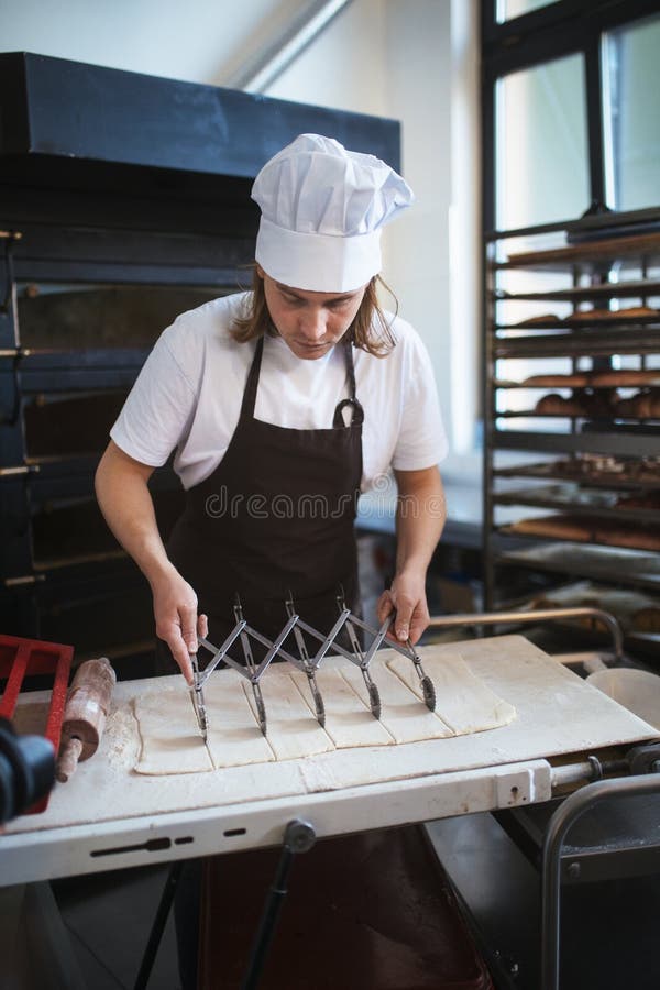 Young Baker Preparing Pastries in Bakery. Stock Photo Image of group