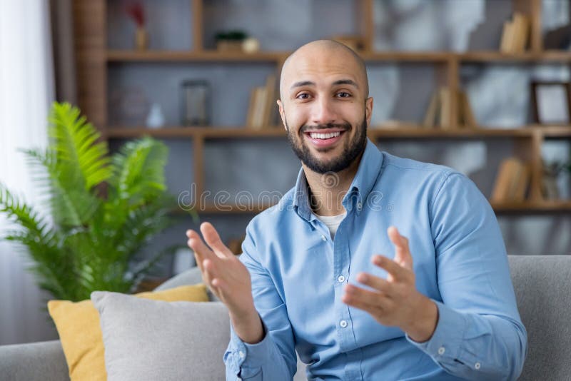 Young man smiling and gesturing during online video call royalty free stock photos