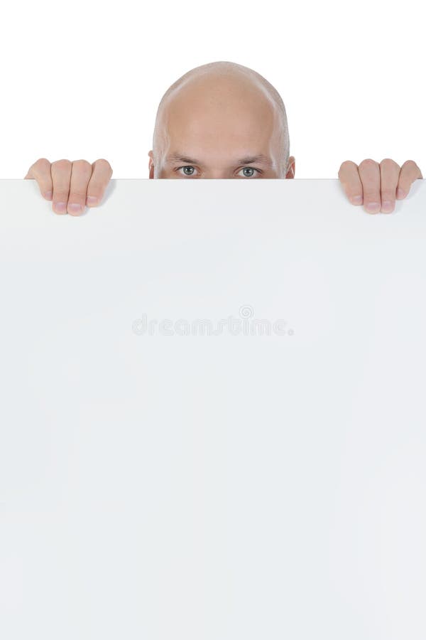 Young bald man holding large blank. royalty free stock image