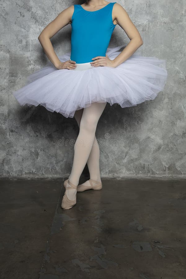 Young Ballerina Dancer Dancing Classical Ballet Against Rustic Wall