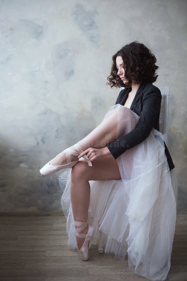 Young ballerina or dancer girl putting on her ballet shoes stock photos Young ballerina or dancer girl putting on her ballet shoes stock photos