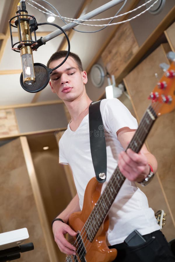 Young Bass Player Standing with His Guitar Stock Photo Image of face
