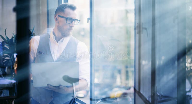 Young Bearded Businessman Wearing Glasses White Shirt Waistcoat Office.Man Holding Modern Laptop His Hands Looking