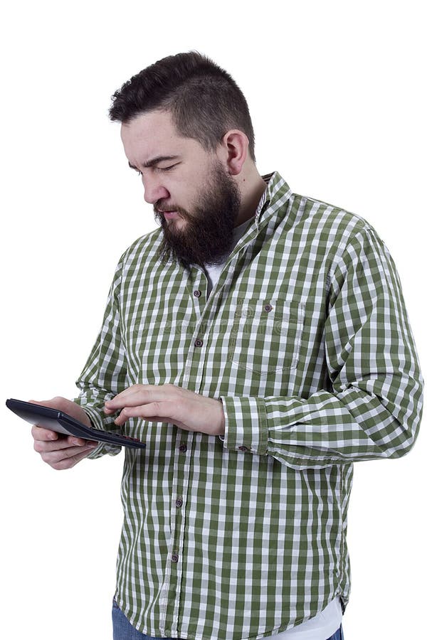 Young bearded man counts on a calculator