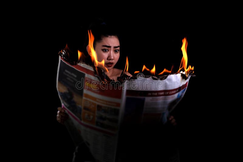 Young Beautiful Asia Woman is Holding Lit and Reads a Fire Burning Newspaper  at the Black Background Stock Photo - Image of economy, fireworks: 180843246