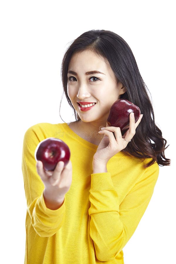 Young beautiful asian woman holding two apples royalty free stock photos Young beautiful asian woman holding two apples royalty free stock photos