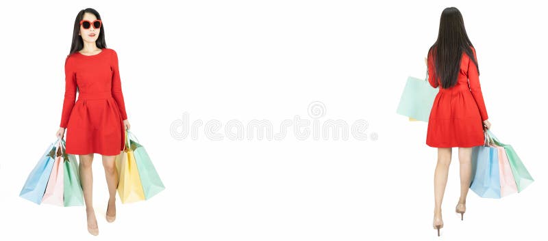 Young beautiful asian woman in red dress wearing fashion sunglasses carrying color pastel shopping bag isolated on white banner