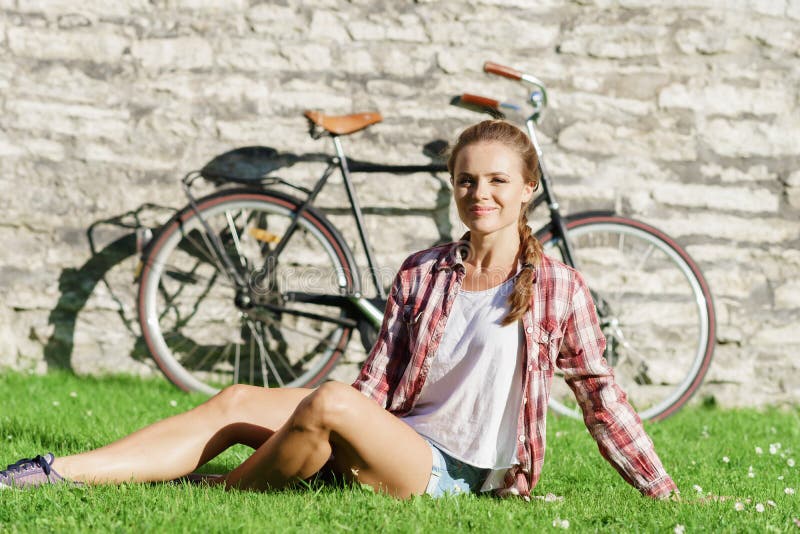 Young, beautiful attractive hipster girl relaxing in park.