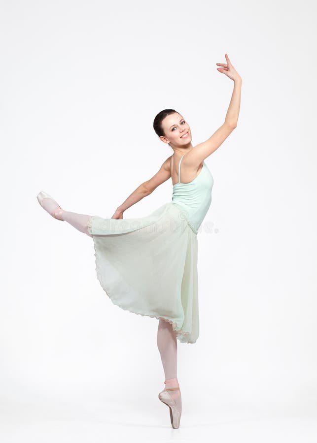 Young beautiful ballerina on a blue background stock photo