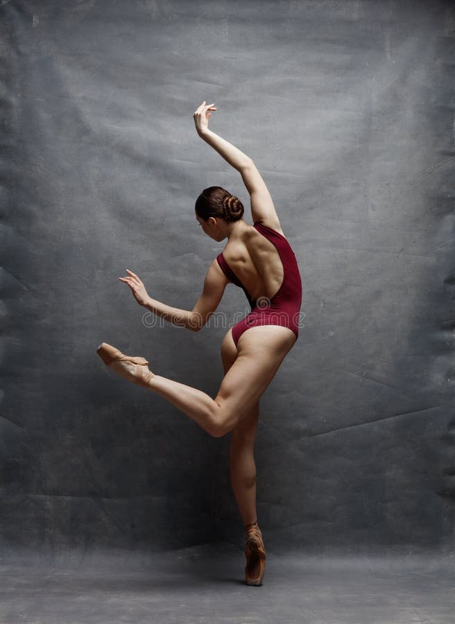 Young beautiful ballerina is posing in studio stock photo
