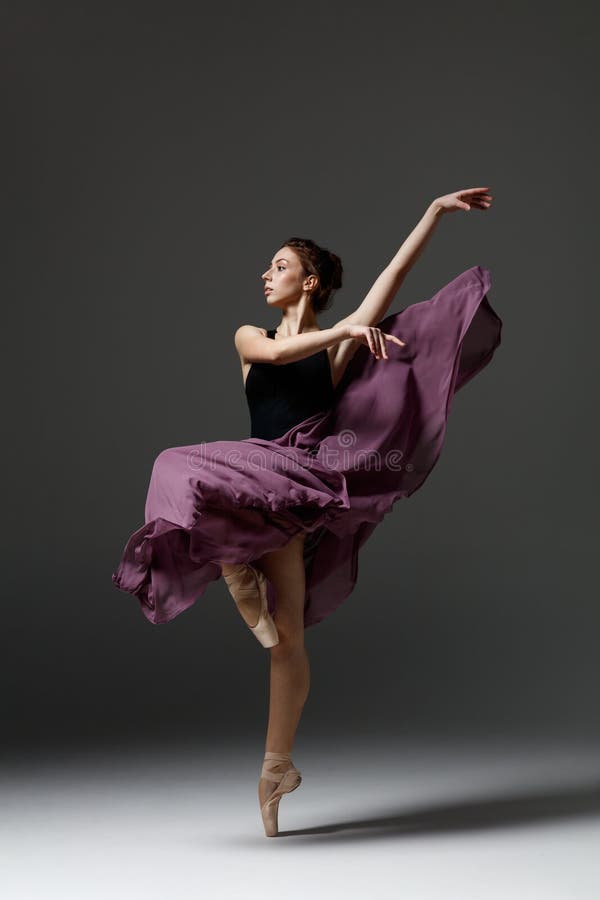 Young beautiful ballerina is posing in studio stock image