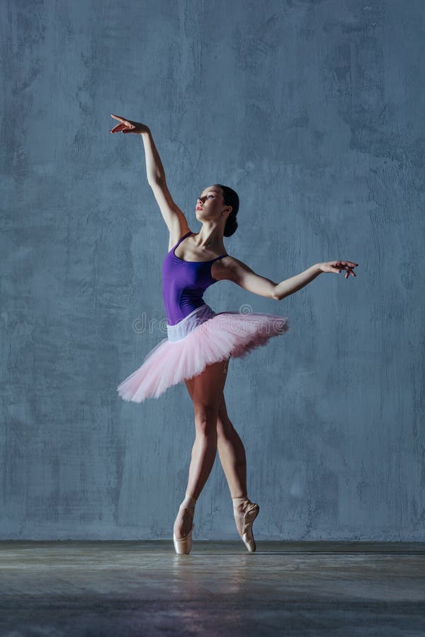 Young beautiful ballerina is posing in studio stock image