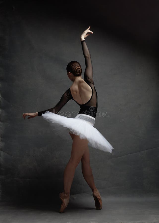 Young beautiful ballerina is posing in studio royalty free stock image