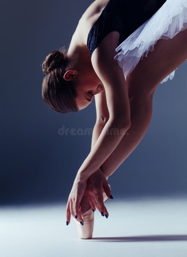 Young beautiful ballerina is posing in studio royalty free stock image