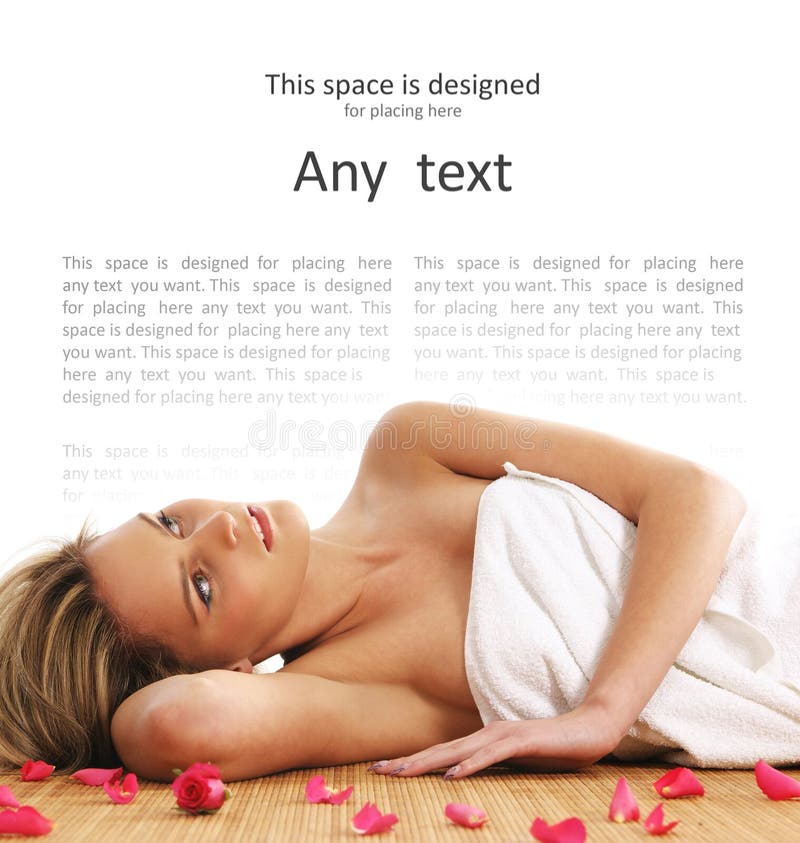 A young and beautiful blond is lying in a towel