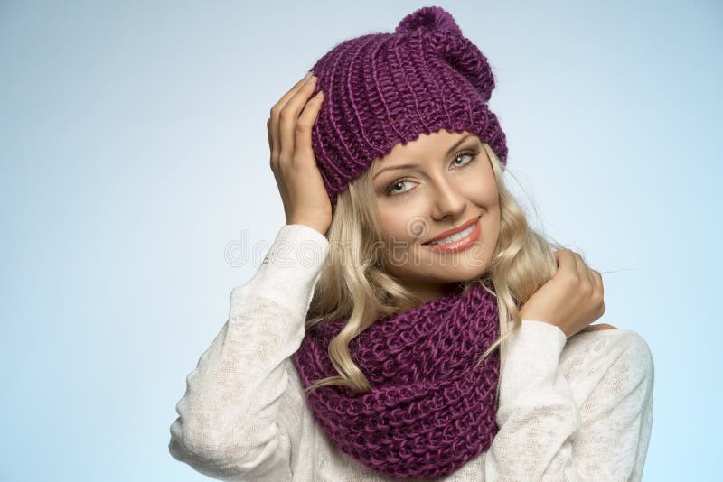 Young beautiful blond wearing scarf and winter hat