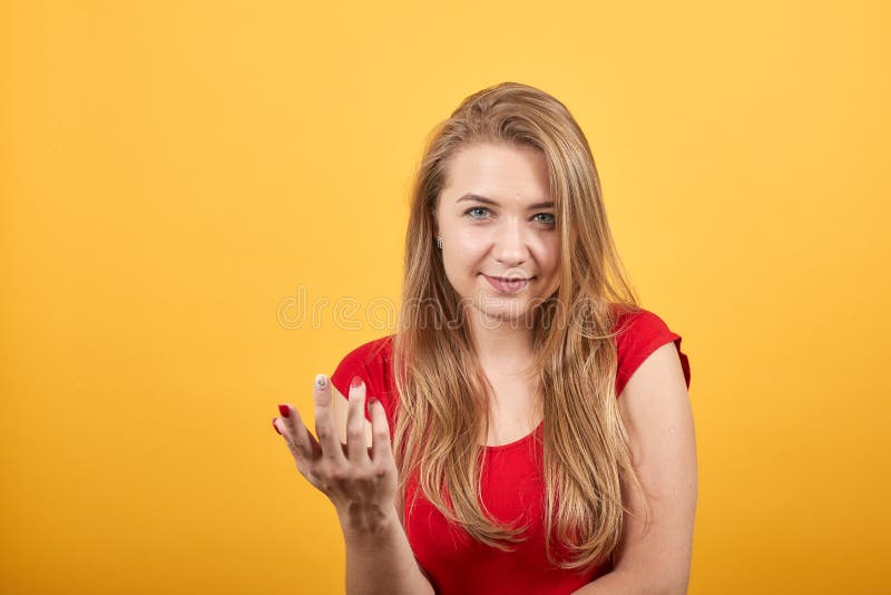 Young Blonde Girl In Red T Shirt Over Isolated Orange Background Shows