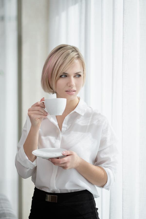 Young Beautiful Blonde Girl with Short Hair in a White Shirt and Glasses is Sitting on the Sofa in Bright in the Office Stock Photo - Image of modern, break: 156542370 Young Beautiful Blonde Girl with Short Hair in a White Shirt and Glasses is Sitting on the Sofa in Bright in the Office Stock Photo - Image of modern, break: 156542370