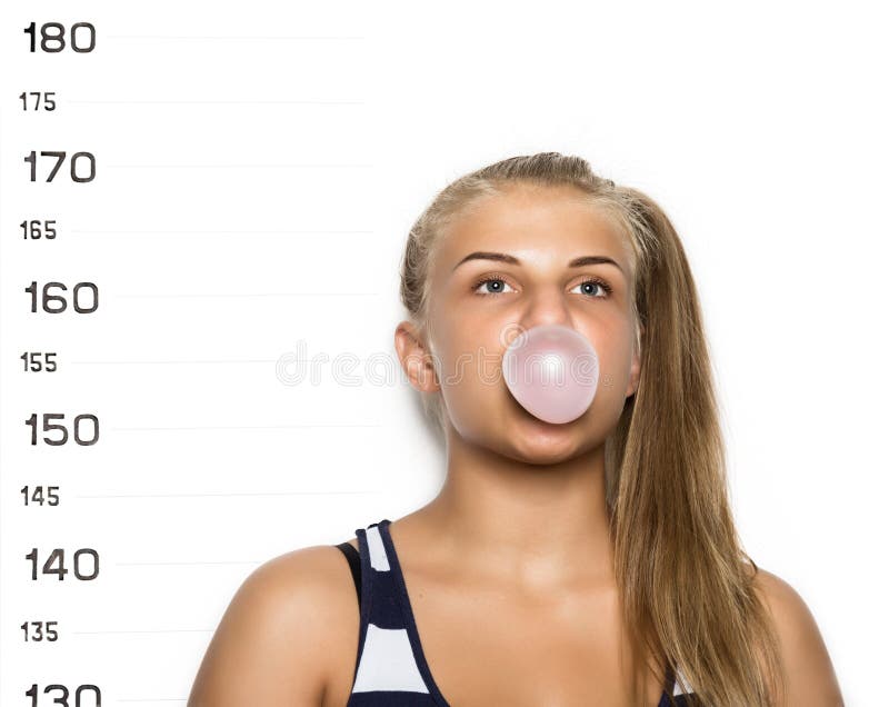 Young beautiful blonde woman chewing gum and blowing bubbles Criminal Mug Shots.