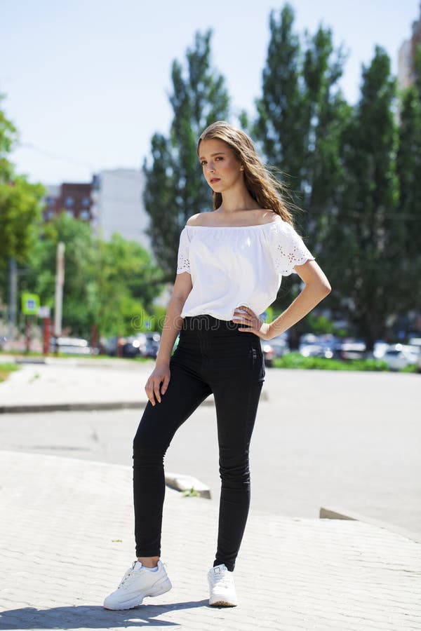 Young Beautiful Brunette Woman in Jeans and White Blouse Walking in ...