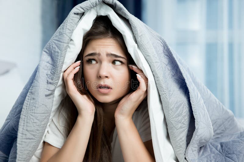 Young Beautiful Brunette Woman Sitting In Bed With Blanket On Her Head 