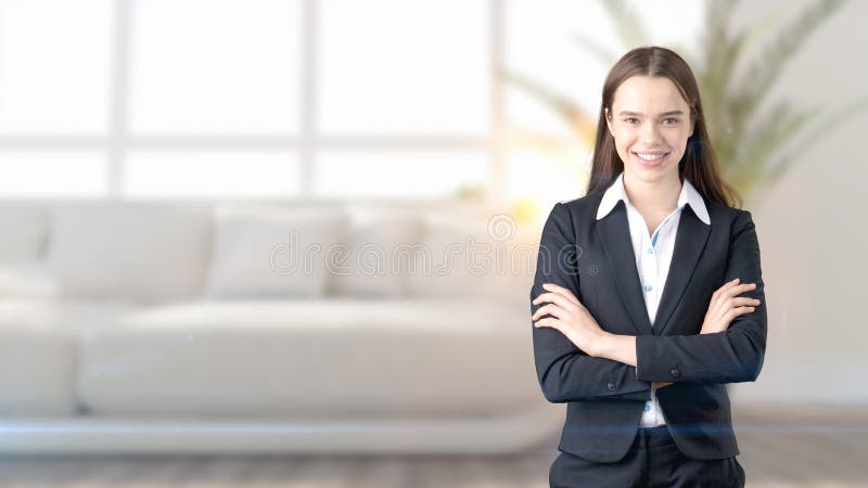 Young beautiful business woman and creative designer standing over blured interior background stock image Young beautiful business woman and creative designer standing over blured interior background stock image