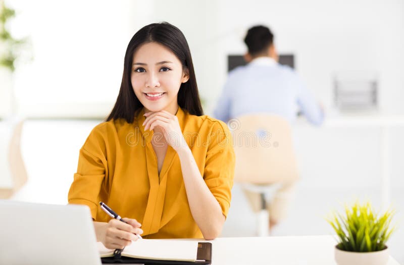 Young beautiful business woman working in office