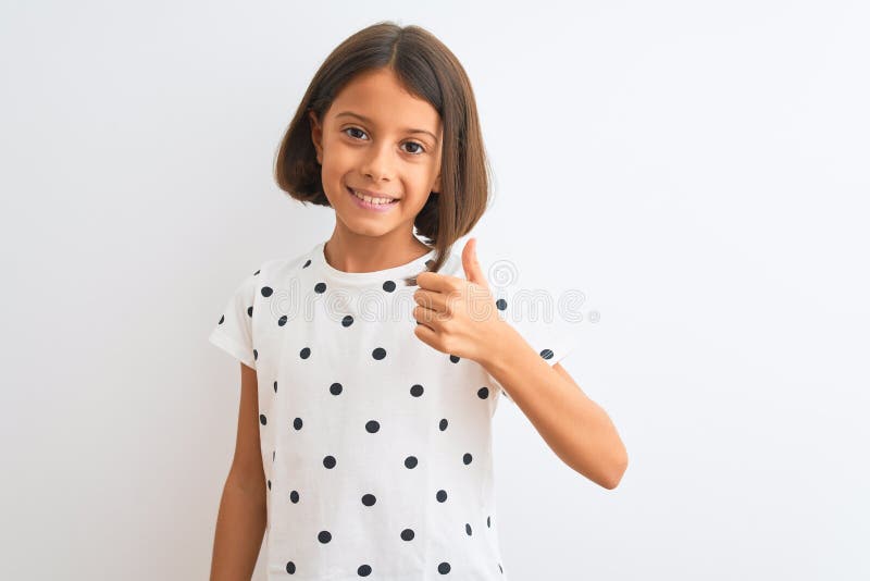 Young beautiful child girl wearing casual t-shirt standing over isolated white background doing happy thumbs up gesture with hand