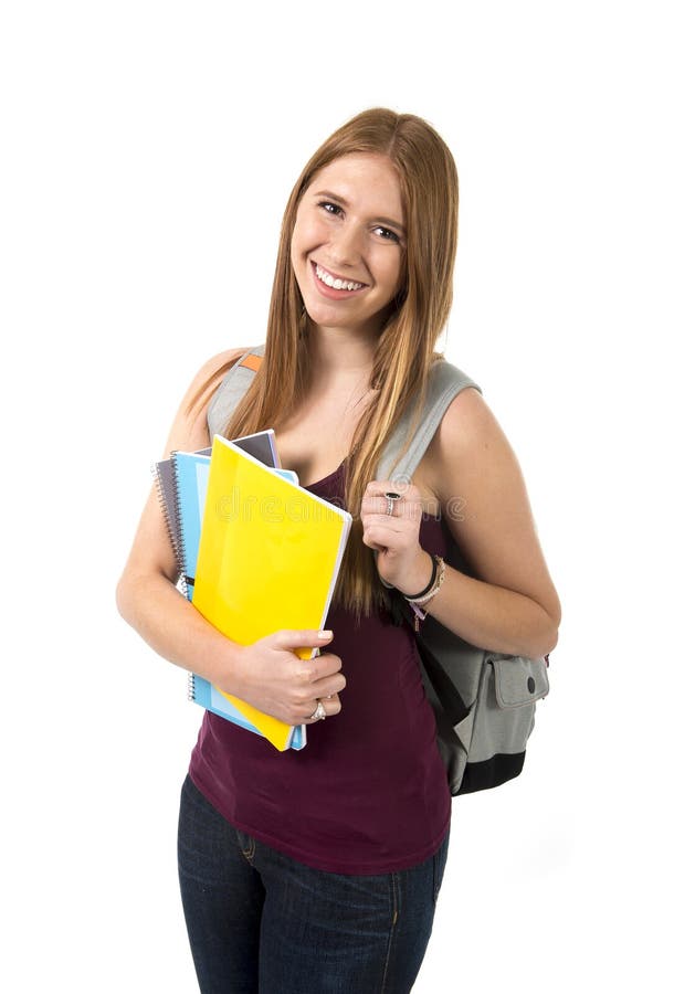 Young beautiful college student girl carrying backpack and books posing happy and confident in university education concept