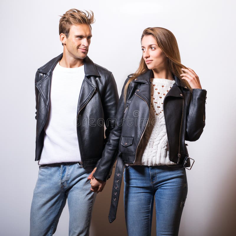 Young Beautiful Couple in Black Leather Jackets Pose in Studio. Stock ...