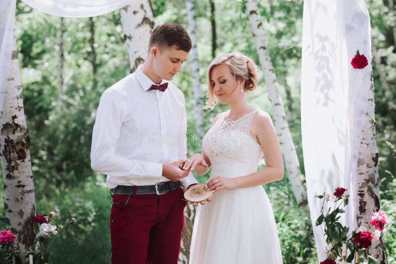 Young beautiful couple, bride and groom in the forest. Against the background of the wedding decor. royalty free stock images Young beautiful couple, bride and groom in the forest. Against the background of the wedding decor. royalty free stock images