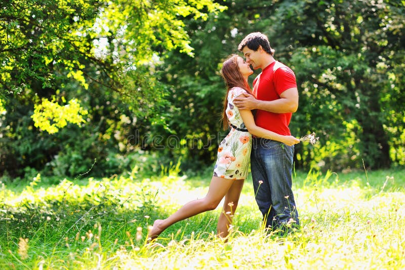 Young Beautiful Couple. Laugh and Kiss. Summer Green Park Stock Photo ...