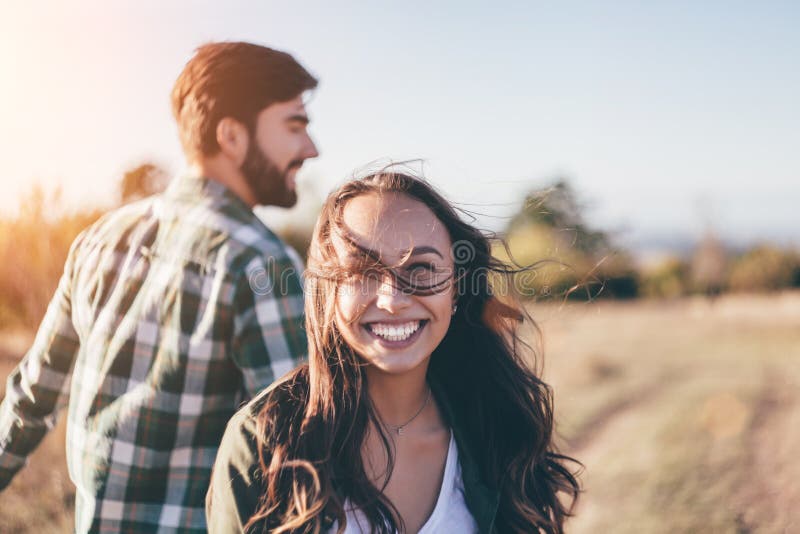 Young beautiful couple walking outside on beautiful sunset. royalty free stock image Young beautiful couple walking outside on beautiful sunset. royalty free stock image